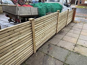 Contemporary horizontal batten fencing along garden boundary