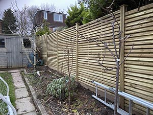 KDM batten style fence panels between concrete posts