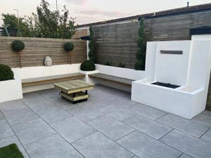 Garden with patio paving and batten fencing